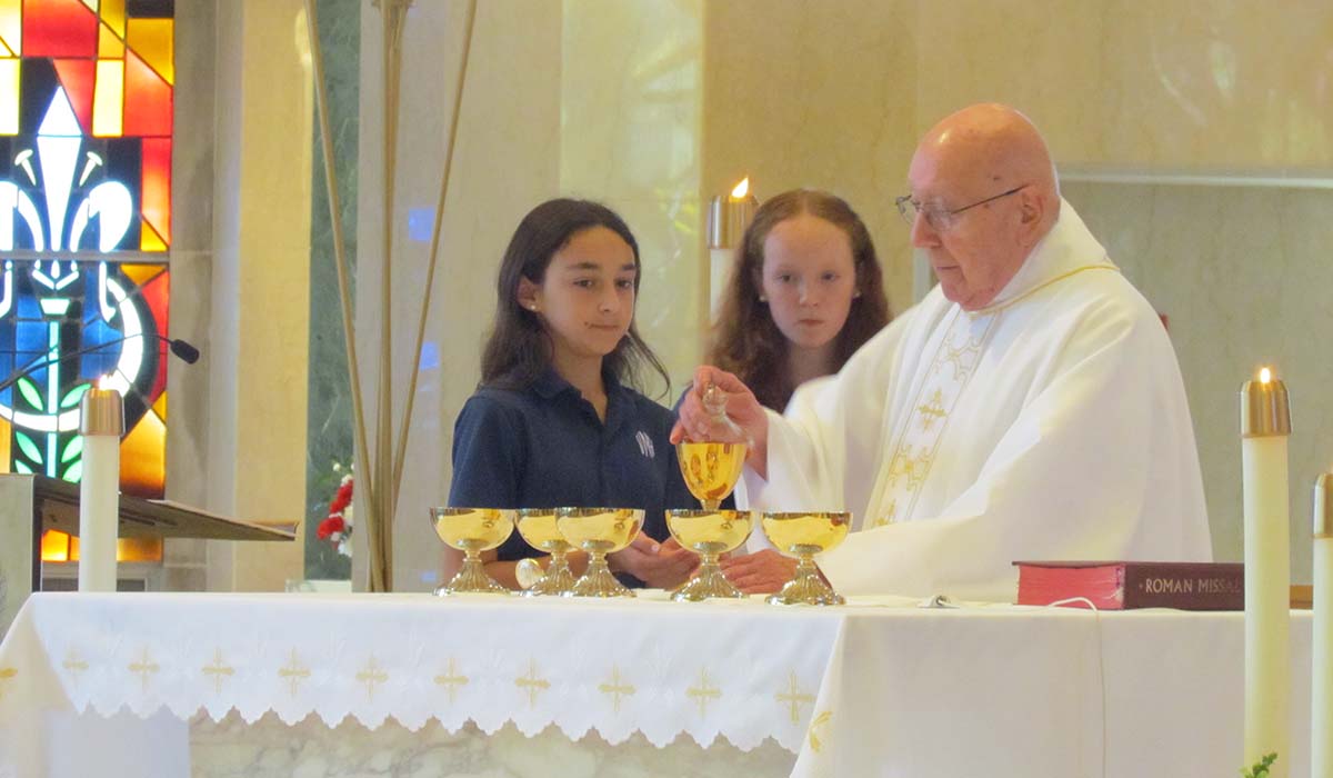 Priest and Villa Maria girls in church